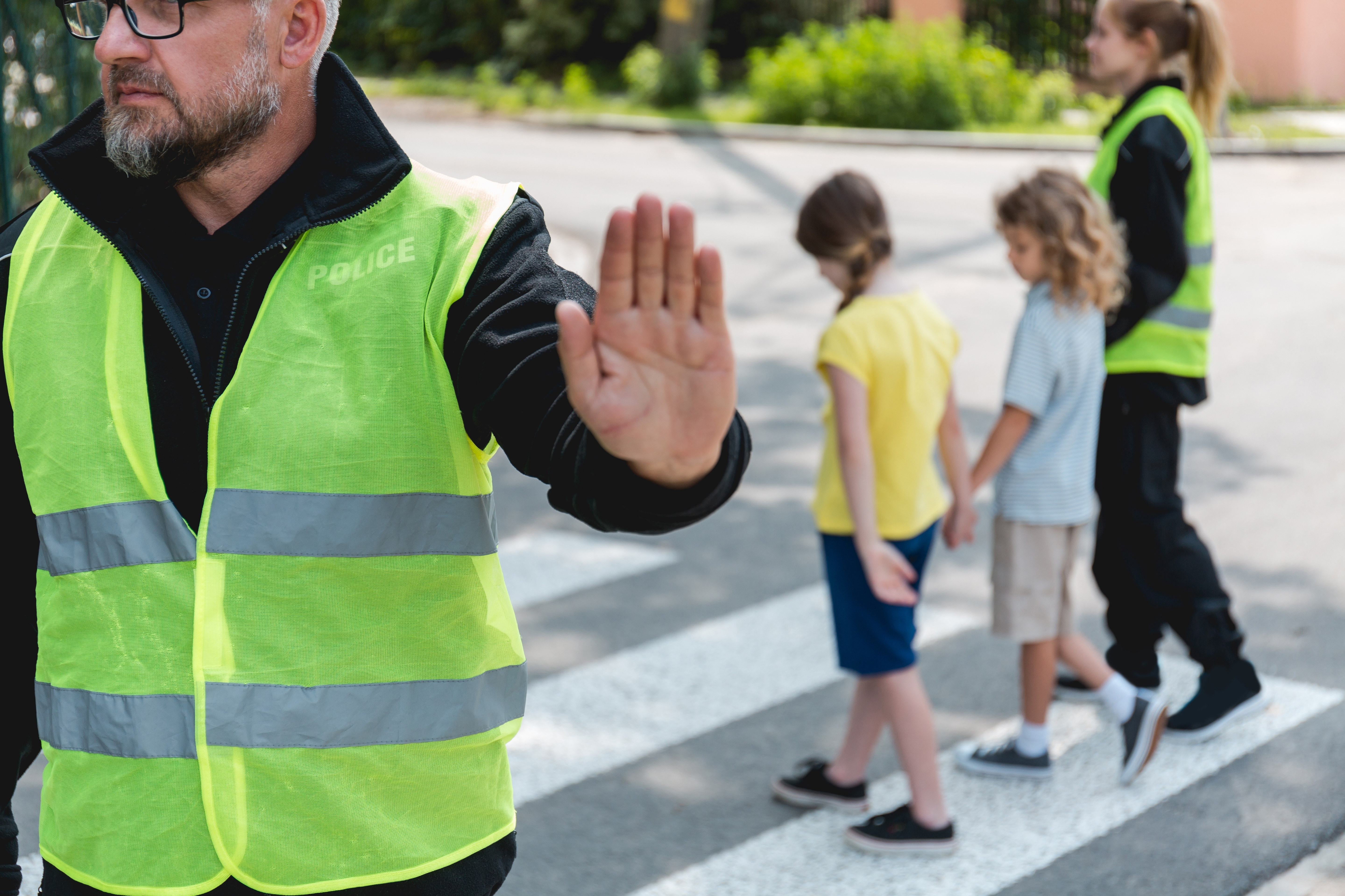 Children and crossing guards practicing school safety